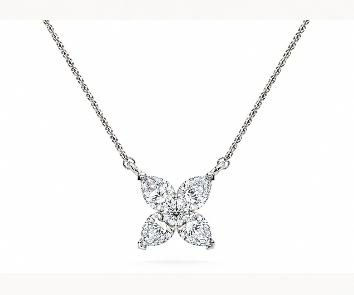 Bruma Andina · Dije floral con diamante redondo y cuatro diamantes pera — Oro blanco 18k